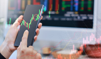 Businessman holding smartphone with glowing stock market chart and upward arrow. Financial growth, investment success, fintech, and trading technology concept. business stock market.