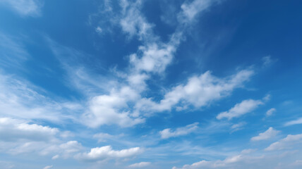Obraz premium Blue sky scattered with white clouds, minimal and peaceful atmosphere, natural outdoor daylight scene