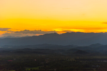 Sunset mountain range beautiful landscape mist foggy sunrise beam. Golden sky Mountain landscape foggy windy mountain. Amazing Landscape cloud sky on sunrise. Countryside gold sunlight heaven scene