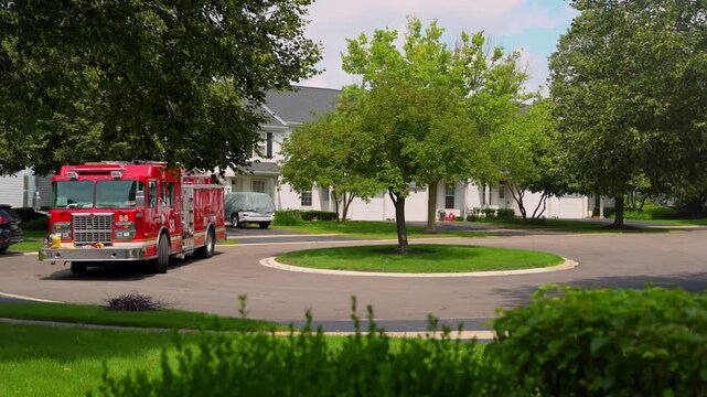 Firetruck Responds to house call in suburbs . Day time.