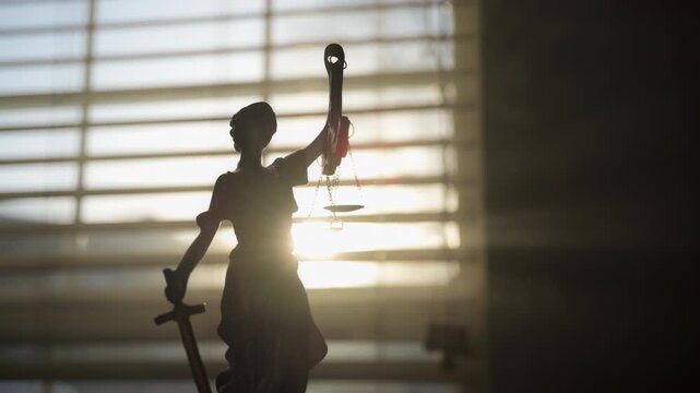 Justice Statue on foggy and light from windows on background. Close up view of Move camera