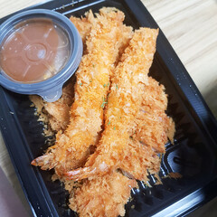 A close-up of a plate of crispy fried shrimp, a savory and popular snack or side dish.