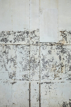 Weathered wall shows signs of age with peeling paint, and texture creates an abstract background.