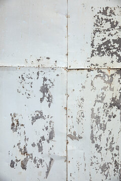 Weathered wall shows signs of age with peeling paint, and texture creates an abstract background.