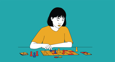 Fototapeta premium Asian girl playing game at table on solid color background, using board game piece