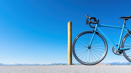 High-End Carbon Fiber Road Bike Leaning Against a Yellow Post