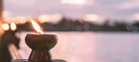 Soul and spirituality for death mourning abstract concept and world human spirit day with warm candlelight candle light bokeh illumination, golden sunset sky and reflective river wave background