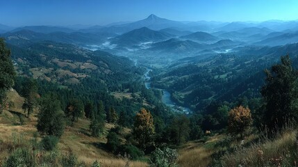 Obraz premium High-angle panoramic view of a valley, misty mountains, and a winding river. Lush greenery, rolling hills, and distant peaks