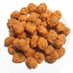 A close-up of a plate of crispy popcorn chicken, a delicious and savory snack.
