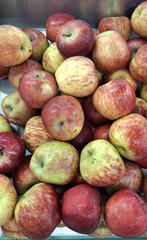 Pile of Fresh Apples. A close-up shot of a large pile of red and yellow apples on a market display. The image captures the natural colors and textures of the fruit.