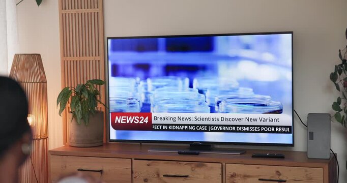 Person, home and watching tv screen for breaking news with virus, pandemic and headlines in lounge. Television show, broadcast and healthcare information for program, report and medical research