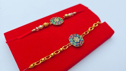 Couple rakhi for bhaiya bhabhi in a red box. Enamel meenakari work multicolor rakhi with gold plating