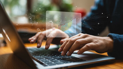 Person typing on a laptop with a holographic financial graph overlay business finance