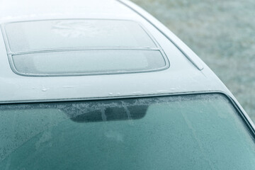 Obraz premium Thick ice layer on car windshield in wintertime