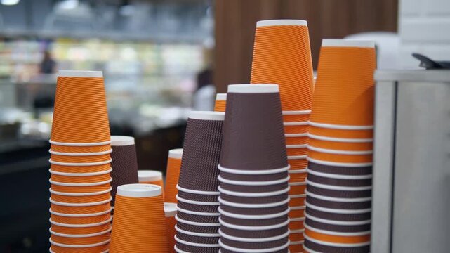 Lots of disposable paper cups for drinks and coffee in different colors.