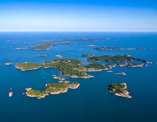 Aerial view of a vast archipelago, numerous islands scattered across a calm sea under a clear blue sky