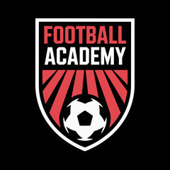 logo emblem for a Football Academy, featuring a soccer ball centered on a shield with red field stripes, all set on a black background