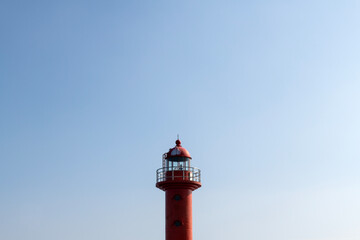 view of the red lighthouse against the blue sky