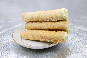 Homemade delights for brunch and morning cravings. Puff pastry stuffed with cheese.Perfect for recipe, freshly baked sweet cinnamon roll isolated on white background,