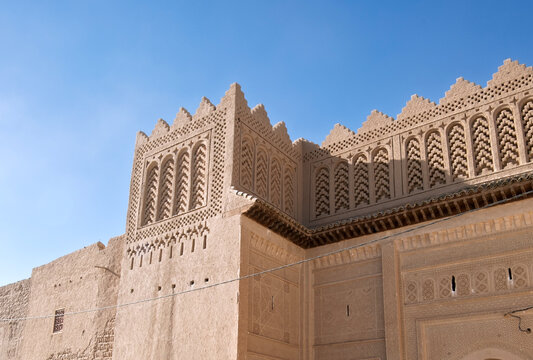 Rissani - Ksar Ouled Abdelhalim detail of upper decoration with motifs in clay bricks. Morocco,  Erg Chebbi Sahara desert, North Africa
