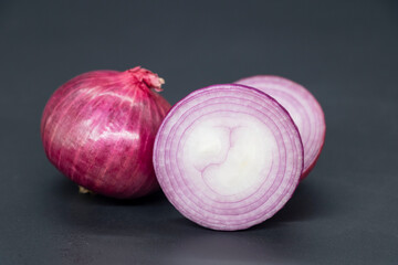 whole and slice Onion, isolated on black background.