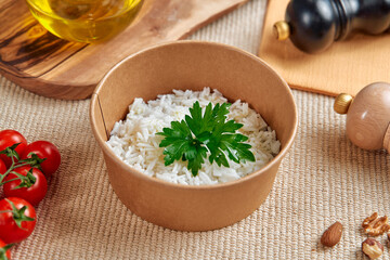 Close-Up of a Bowl Filled with Fluffy White Rice Garnished with Fresh Green Parsley Surrounded by Cherry Tomatoes and Olive Oil
