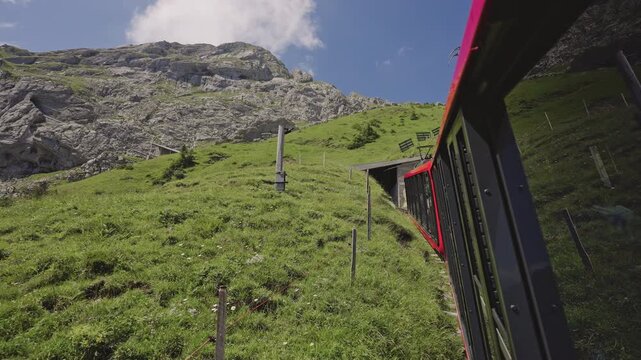 Red Cogwheel Train Climbing Steep Slopes of Mount Pilatus, Switzerland