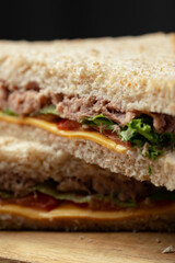 Savory tuna sandwich with fresh lettuce and cheese on whole grain bread served for lunch