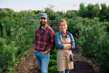Portrait of happy tree nursery workers looking at camera.
