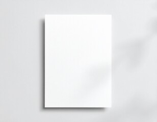 Fototapeta premium Blank white vertical paper sheet 5x7 inches with shadow overlay. Modern and stylish greeting card or wedding invitation mock up.