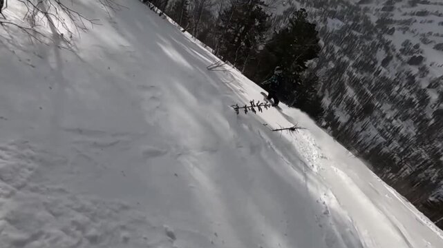 Snowboarding through fresh powder on a steep mountain slope