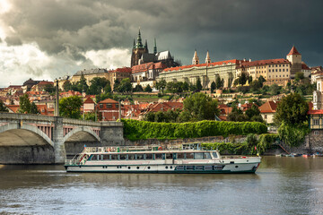 Naklejka premium Czechia tourist ferry boat floats by Mánes Bridge Vltava River Prague
