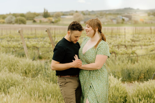 Loving couple embracing in beautiful vineyard scenery