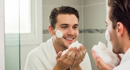 Man applying shaving cream to his face in the bathroom mirror view