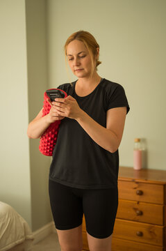 Mobile app for home workout. Woman watching online training