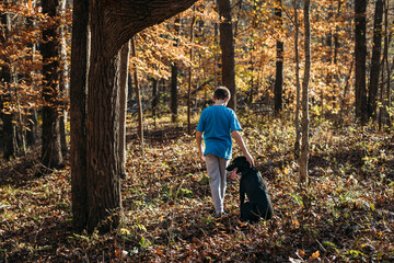 Young boy and dog on fall hike through National Forest © Cavan
