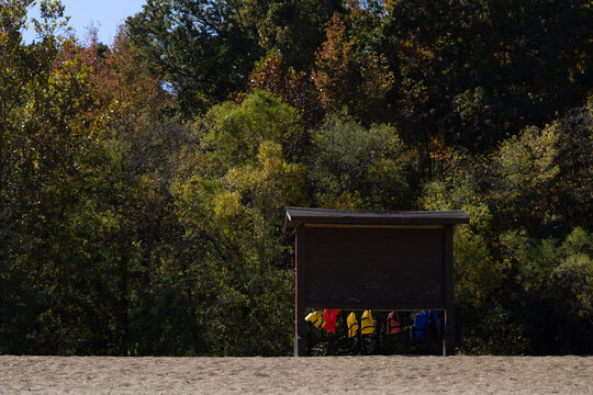 Lifejackets hanging from sign at public beach
