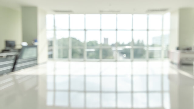Office building lobby blur background or blurry business reception hall, school hallway interior view, blurred empty corridor, glass curtain wall and floor with exterior light illumination