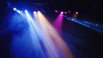 Dynamic stage spotlights illuminate a smoky atmosphere with vibrant purple and yellow beams, creating an energetic and captivating performance environment ready for action. - Powered by Adobe