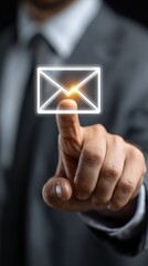 Businessman's finger hovering over a glowing email icon
