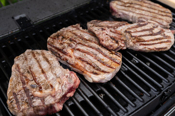 Grilled steaks on outdoor bbq with seared marks