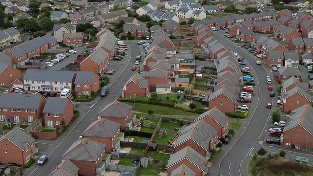 Aerial view above port of Holyhead suburban town neighbourhood brick house property in North Wales