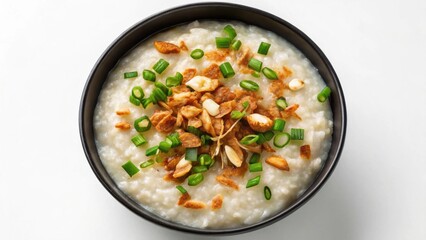 Dim Sum Delicious bowl of rice porridge topped with green onions and crispy nuts.