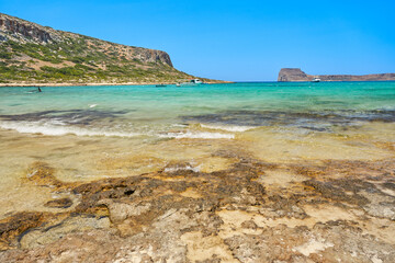 Scenic landscape of the Mediterranean sea on Crete, Greece. Mountains in the background and blue, clear sky.	