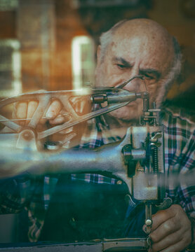 Elderly shoemaker at sewing machine in Cambridge workshop