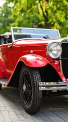 Classic red convertible car in park