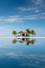 Fototapeta premium Symmetrical reflection photography, tropical island with ocean reflection.