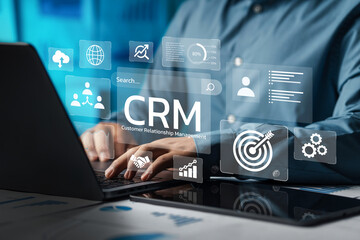 Naklejka premium Businessman using computer and dashboard to analyze CRM data on virtual technology screen with CRM icon, customer relationship management concept for connecting business technology database.