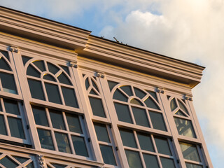 Ornate building facade with arched windows in warm sunset light