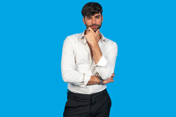 Confident business professional posing against blue background